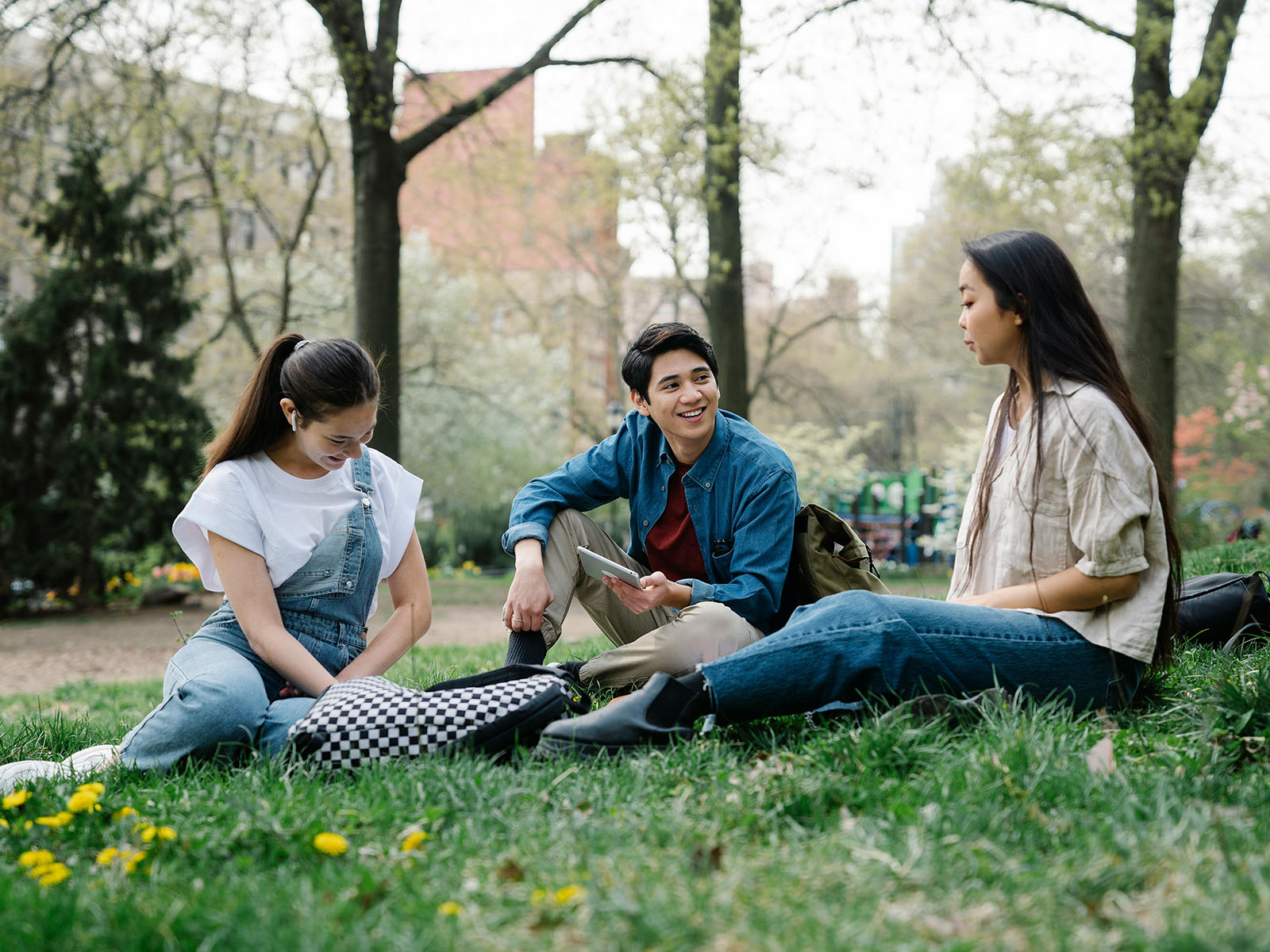 Warren UC - International Private College Consulting - Top Questions to Ask Yourself When Picking a University blog post - three students sitting on grass and talking - Pexels George Pak