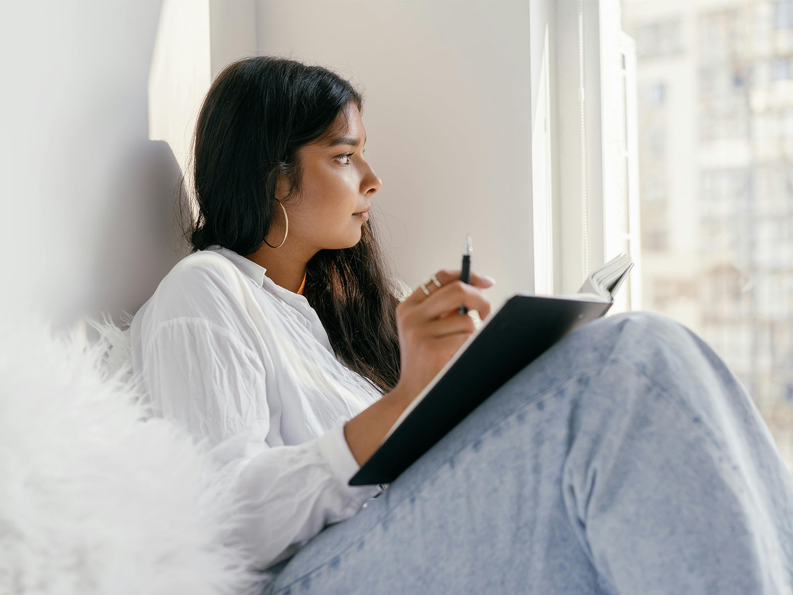 Warren UC - Private International College Consulting - Focus on Quality blog post - Young woman in white shirt looking out window - Pexels Mikhail Nilov