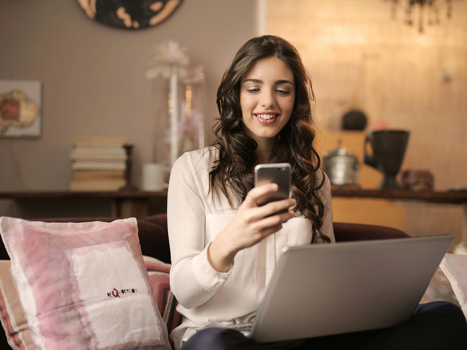 Warren UC - Private International College Consulting - Avoiding Common Mistakes in College Application blog post - Woman Sitting on Sofa While Looking at Phone With Laptop on Lap - Pexels Andrea Piacquadio