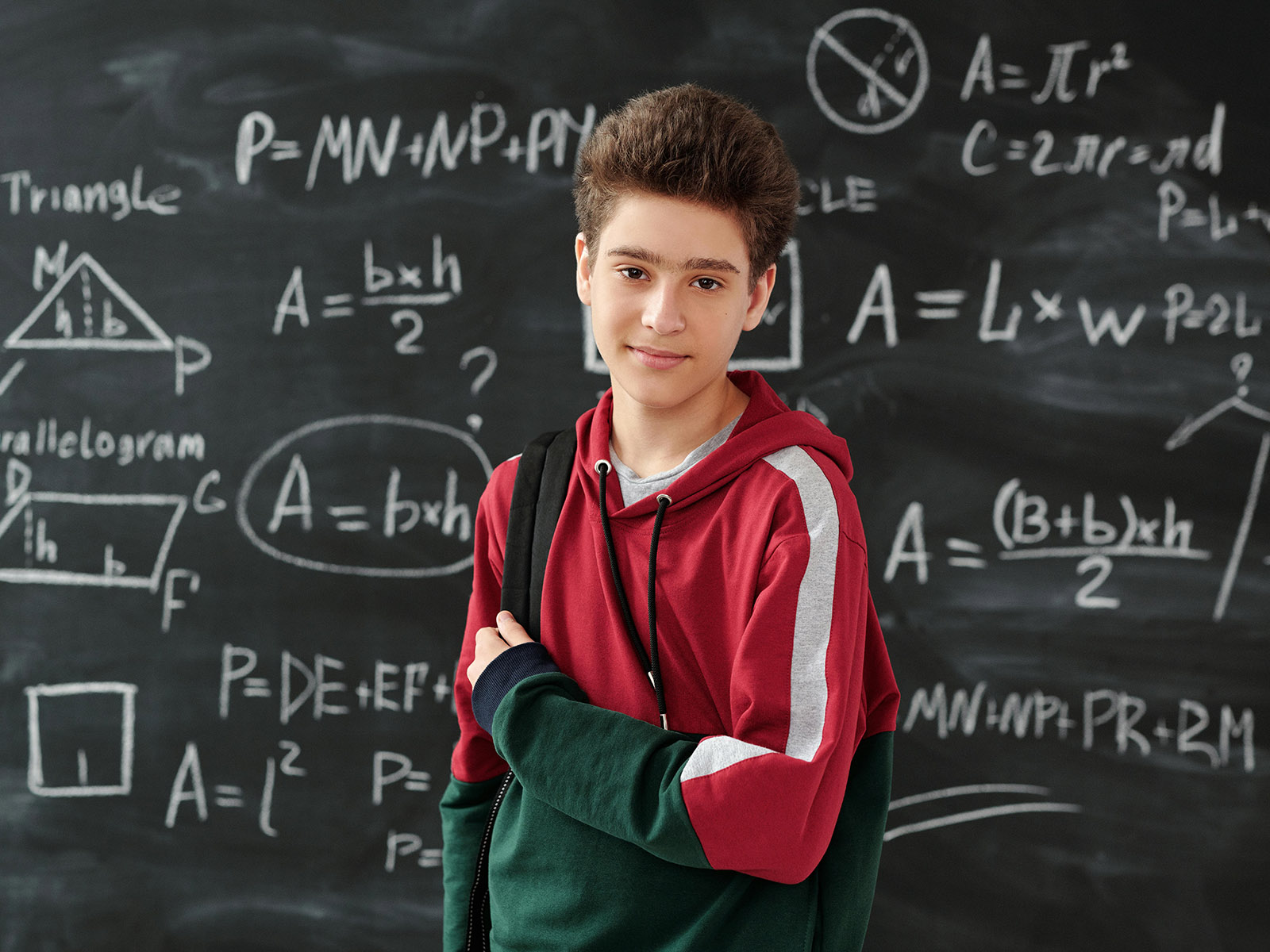 Warren UC - Private International College Consulting - Preparing for an Engineering Degree- What Courses You Need and More blog post - Boy standing in front of math symbols - Pexels Max Fischer