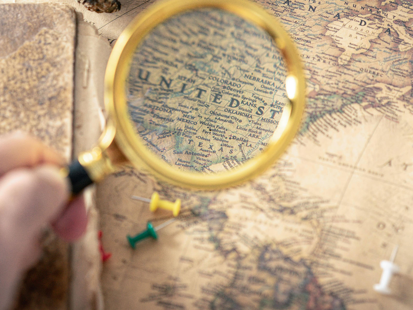 Warren UC - Private International College Consulting - Trump's Impact on Study Abroad post - Person Holding Magnifying Glass on map of USA - Pexels Oleksandr P